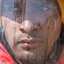 Close-up of man's face behind a plastic faceguard