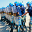 Side view of blu-uniformed men walking in formation some carrying clear shields